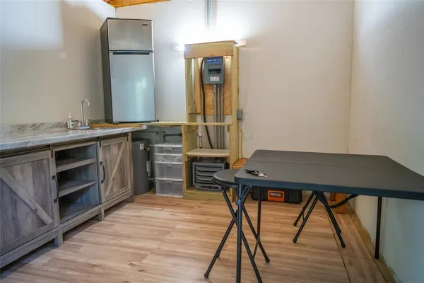 a room with a table chairs and wooden floor
