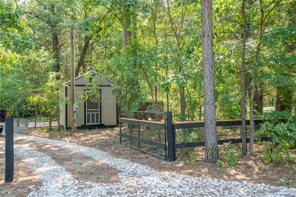 a view of a house with a tree in the background