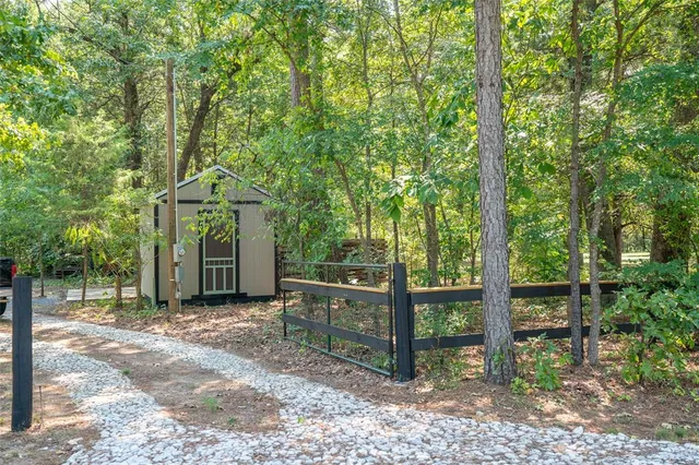 a view of a house with a tree in the background