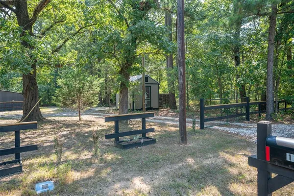 a view of a park with bench sitting area
