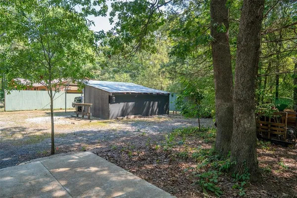 a view of a house with backyard and a tree