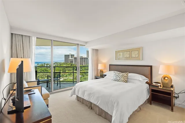 a bedroom with a balcony a bed and a large window with balcony view