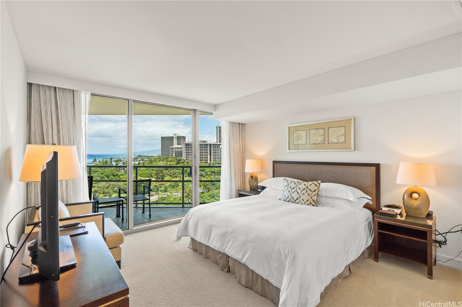 a bedroom with a balcony a bed and a large window with balcony view