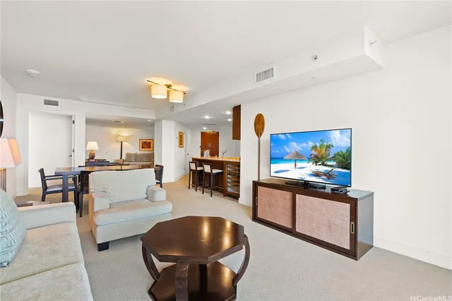 a living room with furniture a dining table and chairs in it