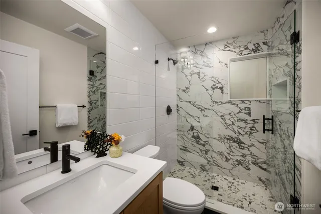 a bathroom with a sink toilet and shower