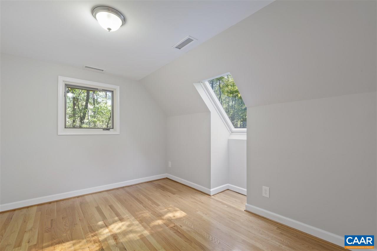 285 Turkey Ridge Road Charlottesville, VA 22903 - Photo 21 of 28 an empty room with wooden floor and window