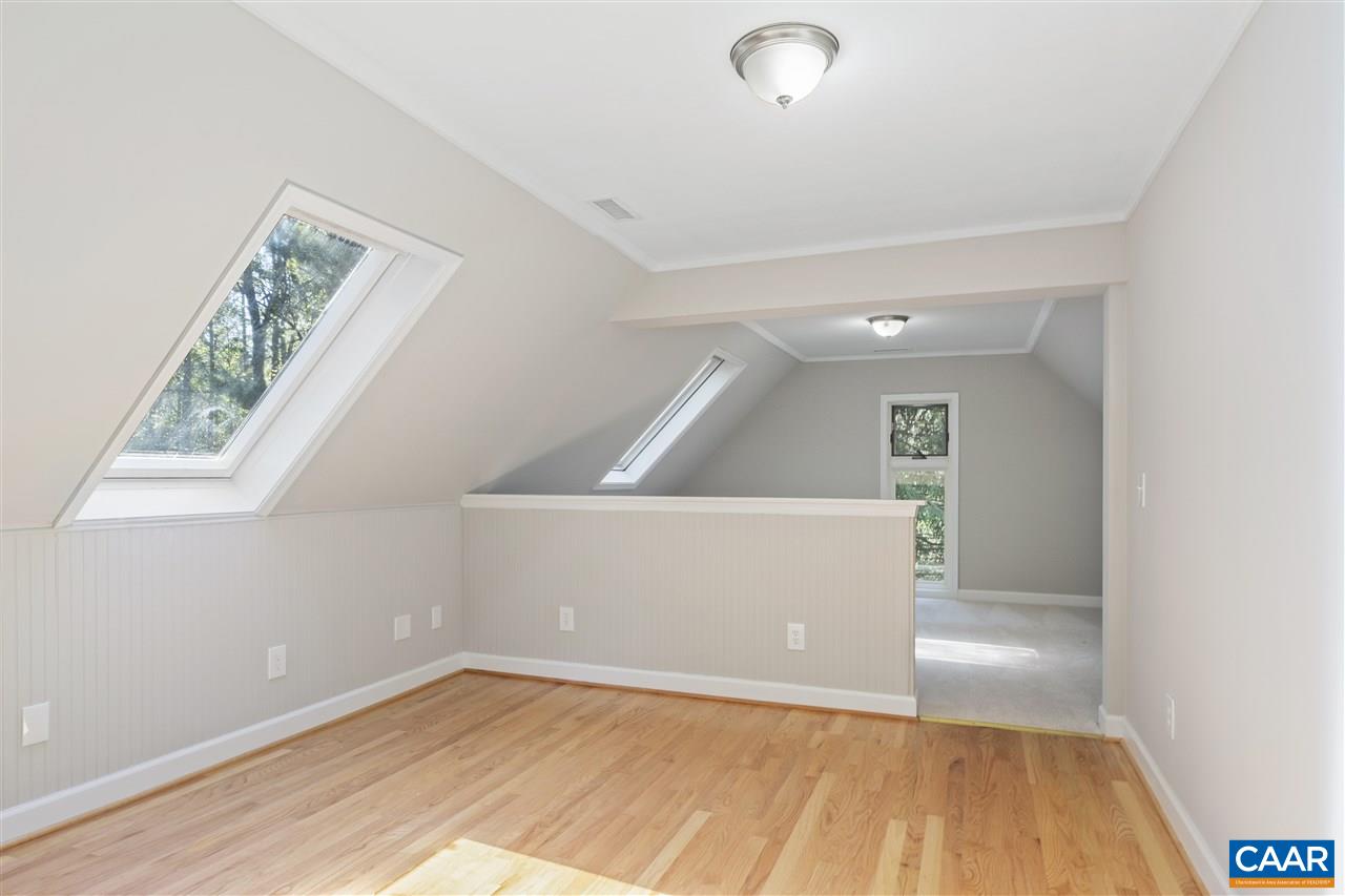 285 Turkey Ridge Road Charlottesville, VA 22903 - Photo 23 of 28 an empty room with wooden floor and windows