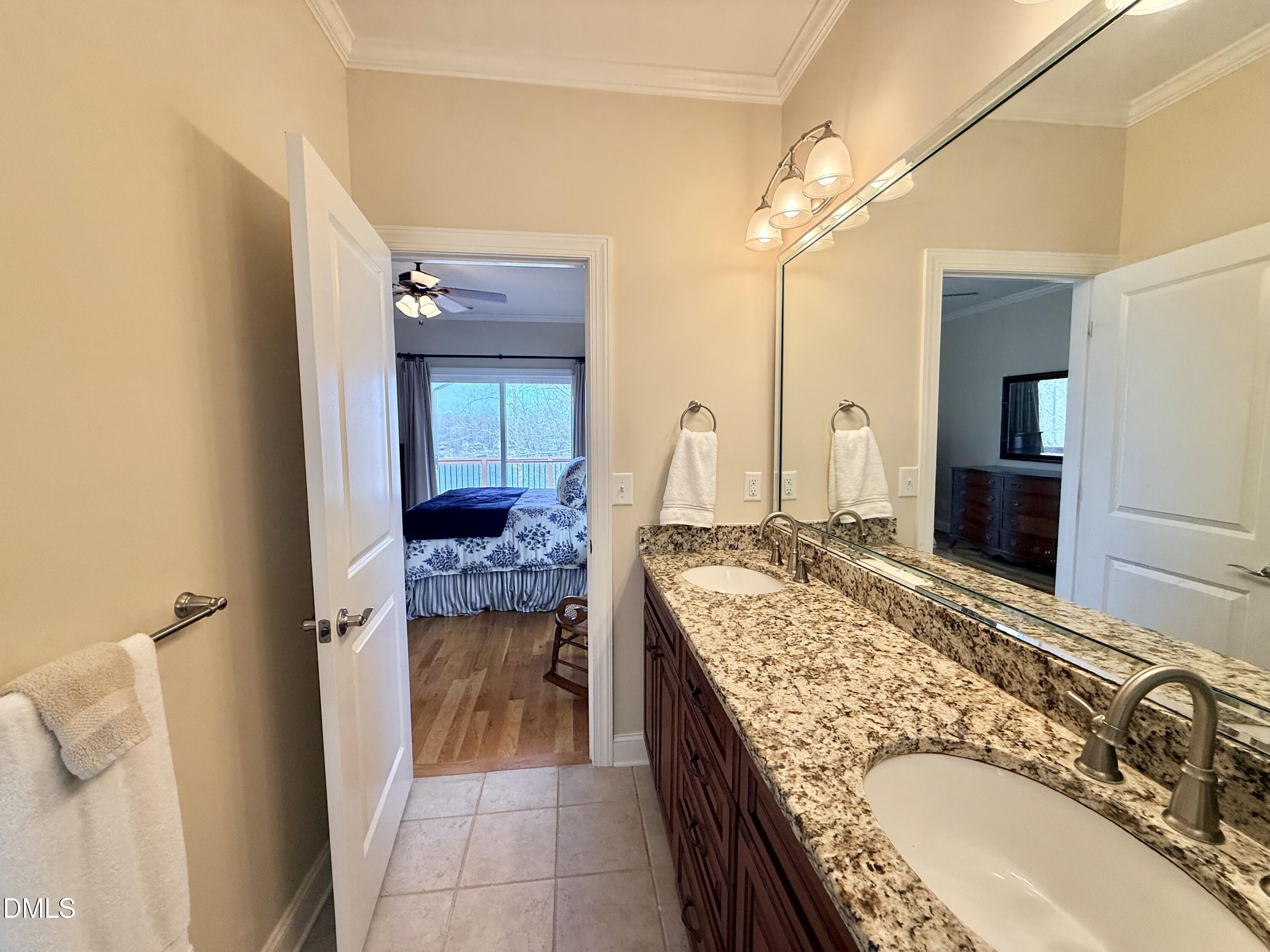 250 Bunny Rabbit Road Leasburg, NC 27291 - Photo 26 of 66 a en suite bathroom with a granite countertop sink and a mirror