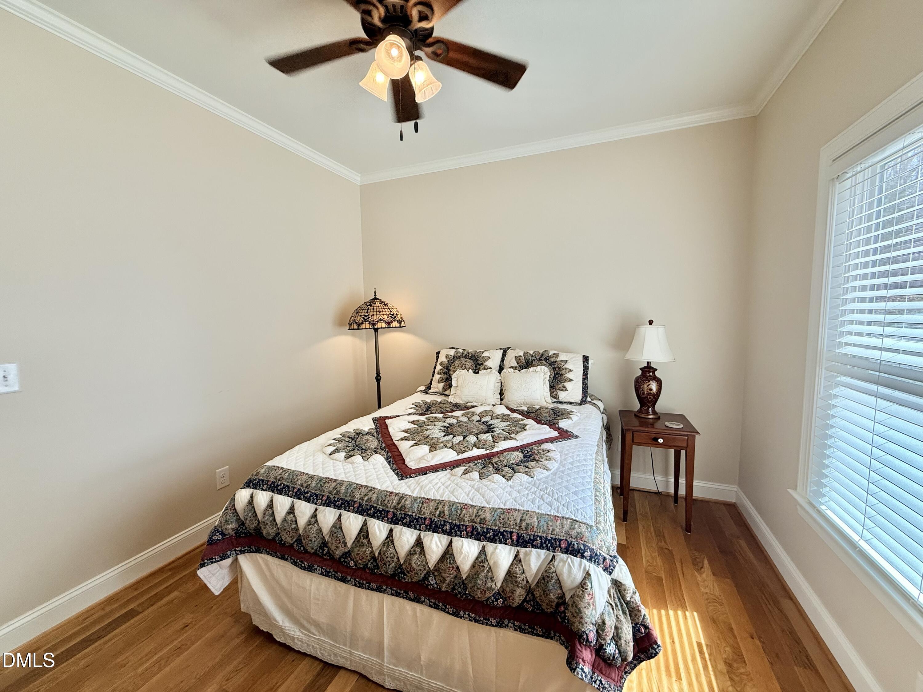 250 Bunny Rabbit Road Leasburg, NC 27291 - Photo 27 of 66 a bedroom with a bed and a table in it
