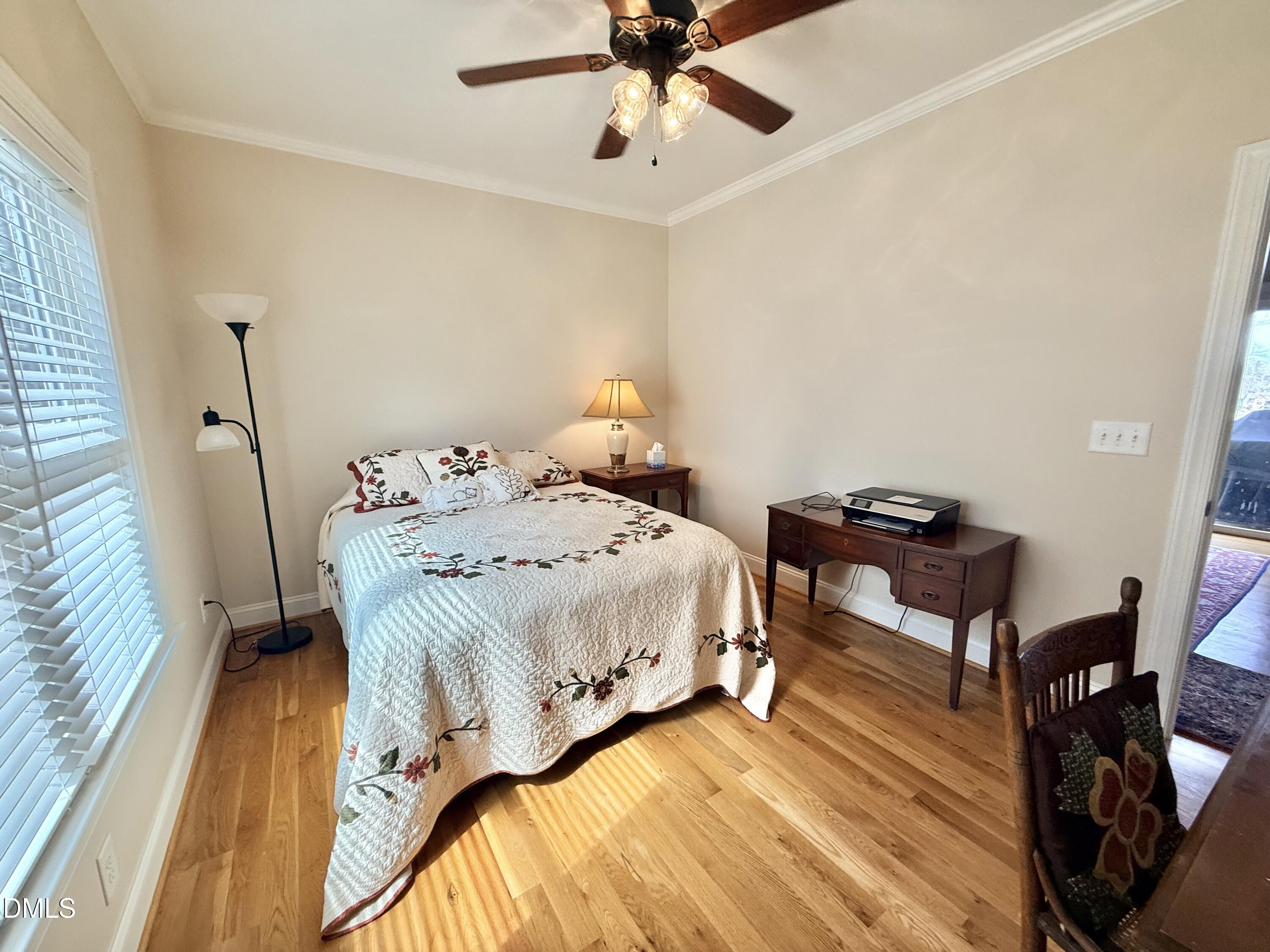 250 Bunny Rabbit Road Leasburg, NC 27291 - Photo 31 of 66 a bedroom with a bed and wooden floor