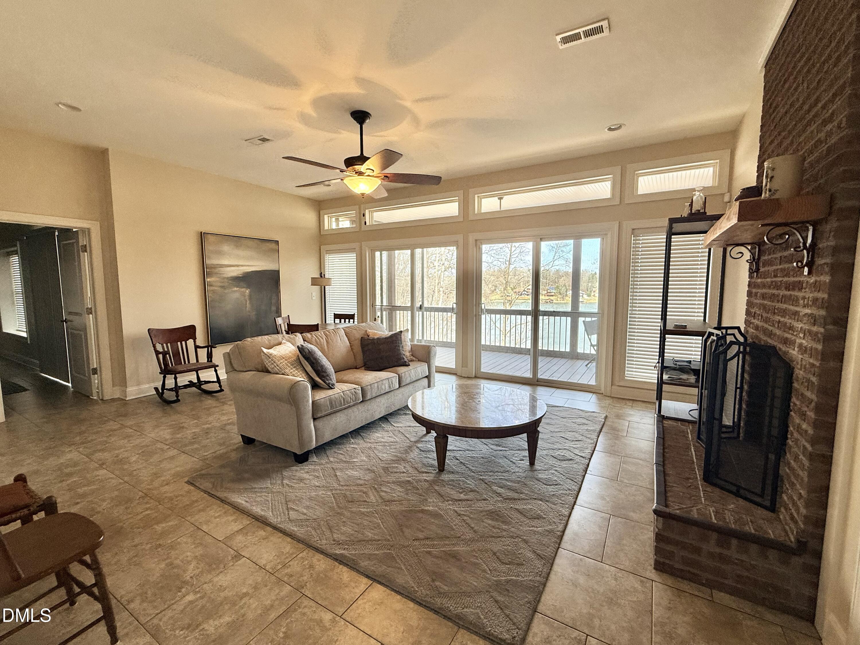 250 Bunny Rabbit Road Leasburg, NC 27291 - Photo 34 of 66 a living room with furniture a flat screen tv and a fireplace