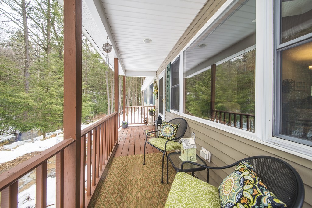 118 Wales Road Monson, MA 01057 - Photo 1 of 30 a balcony with chairs and wooden floor