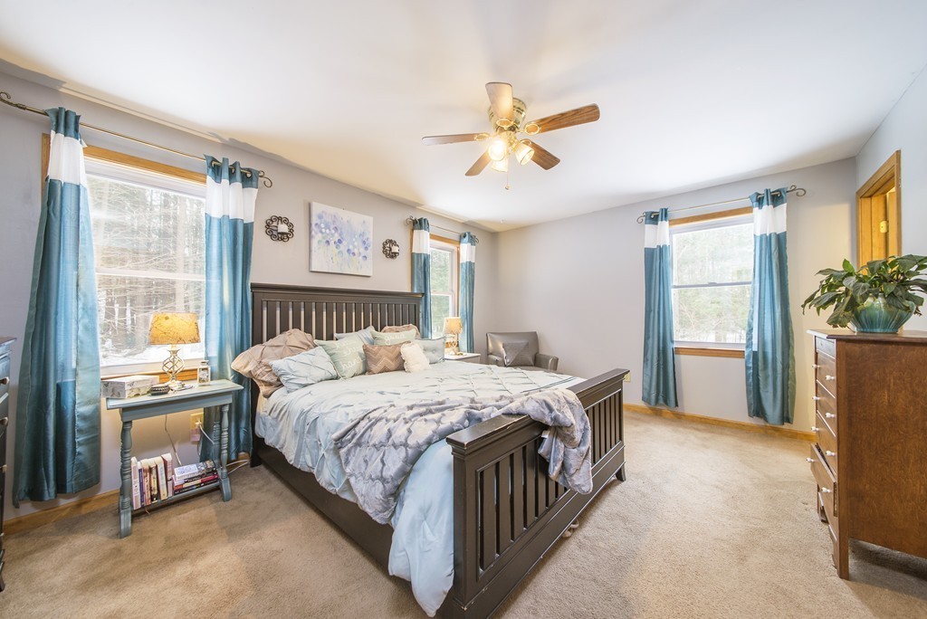 118 Wales Road Monson, MA 01057 - Photo 11 of 30 a bedroom with a bed and a chandelier
