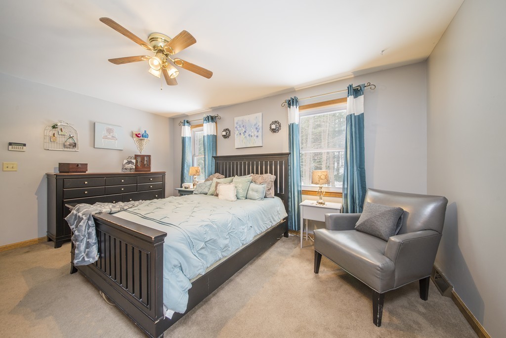 118 Wales Road Monson, MA 01057 - Photo 12 of 30 a bedroom with a bed and a chandelier