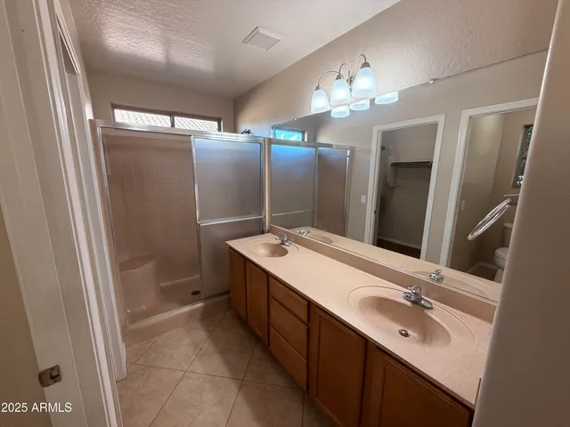 a bathroom with a double vanity sink and a mirror