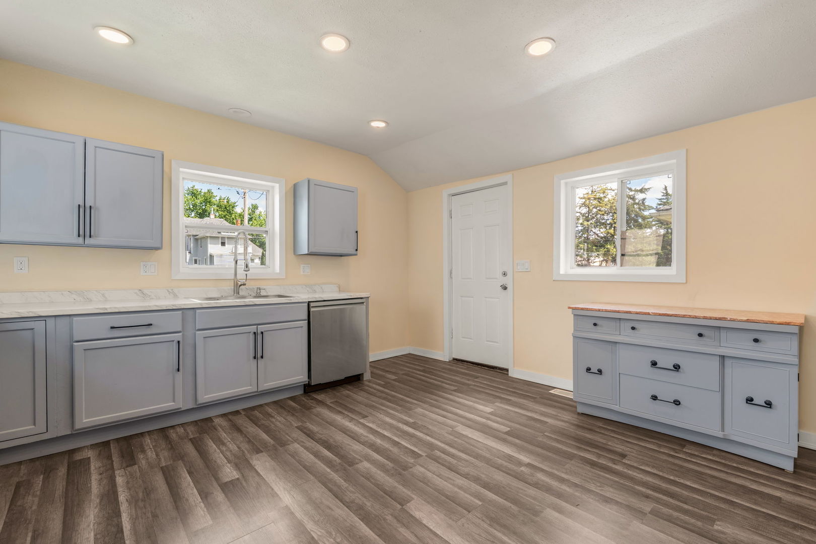 548 7th Avenue South Clinton, IA 52732 - Photo 13 of 23 a kitchen with granite countertop white cabinets sink and window