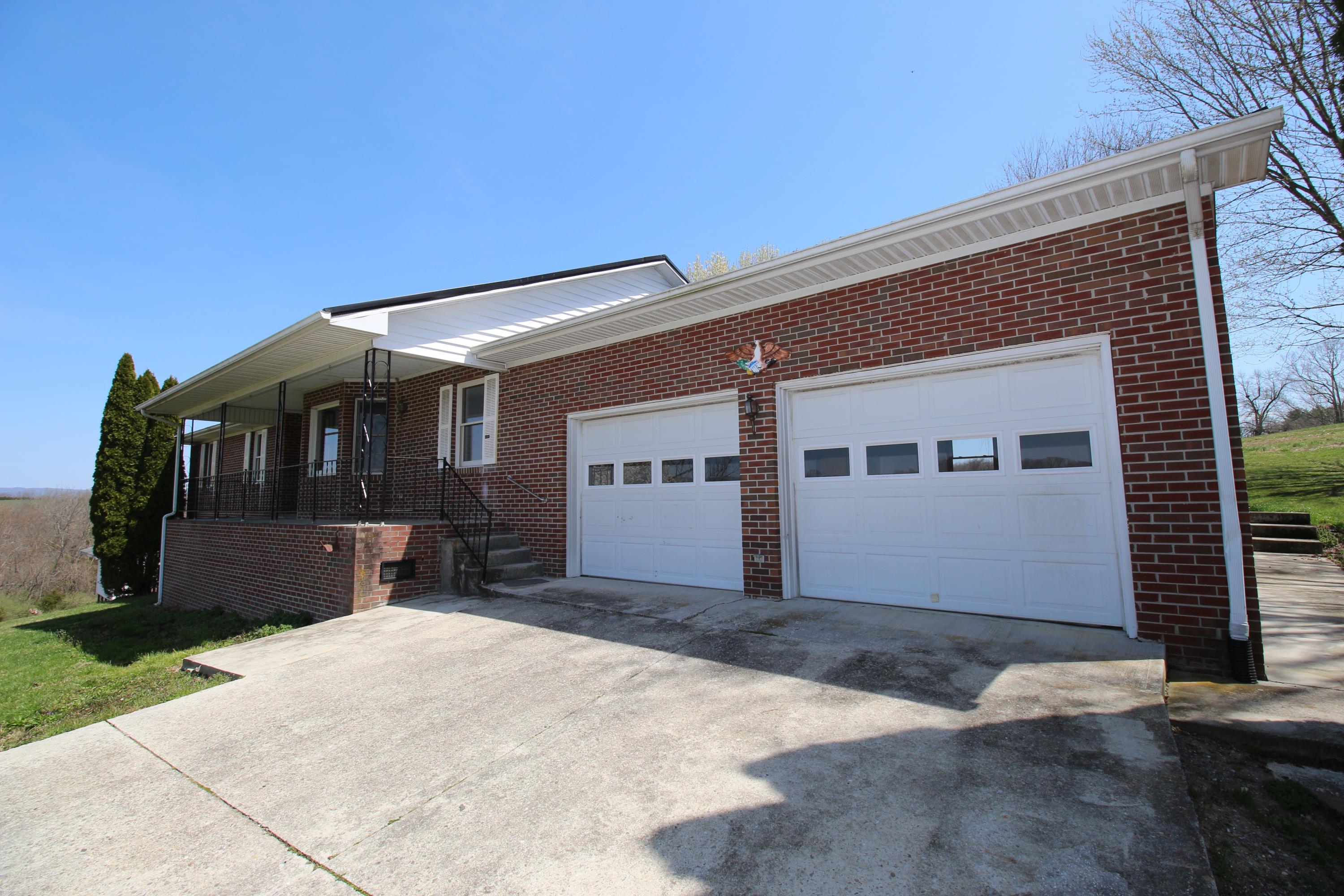 7080 Belspring Road Radford, VA 24141 - Photo 1 of 53 a front view of a house with a yard