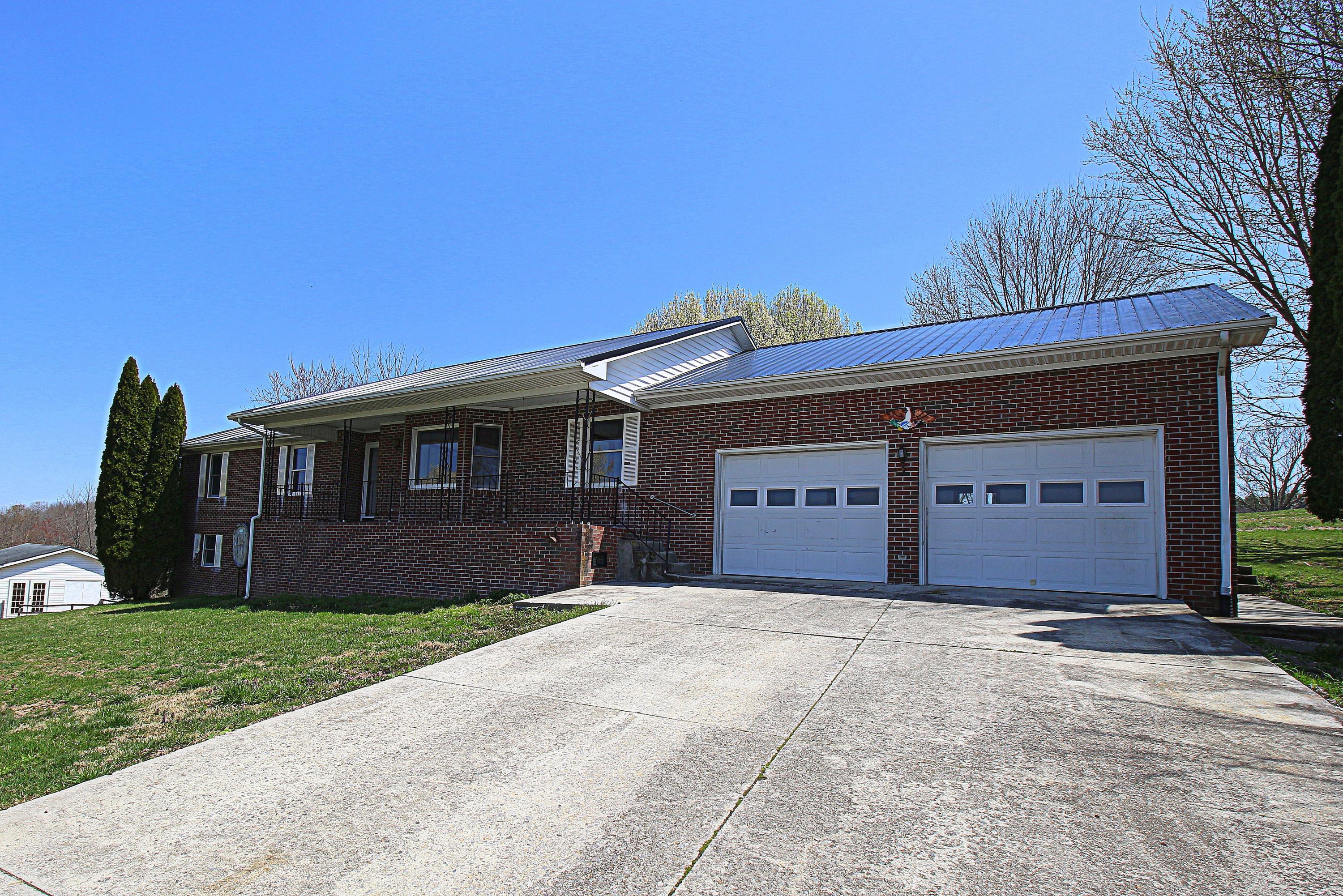 7080 Belspring Road Radford, VA 24141 - Photo 2 of 53 a front view of a house with a yard