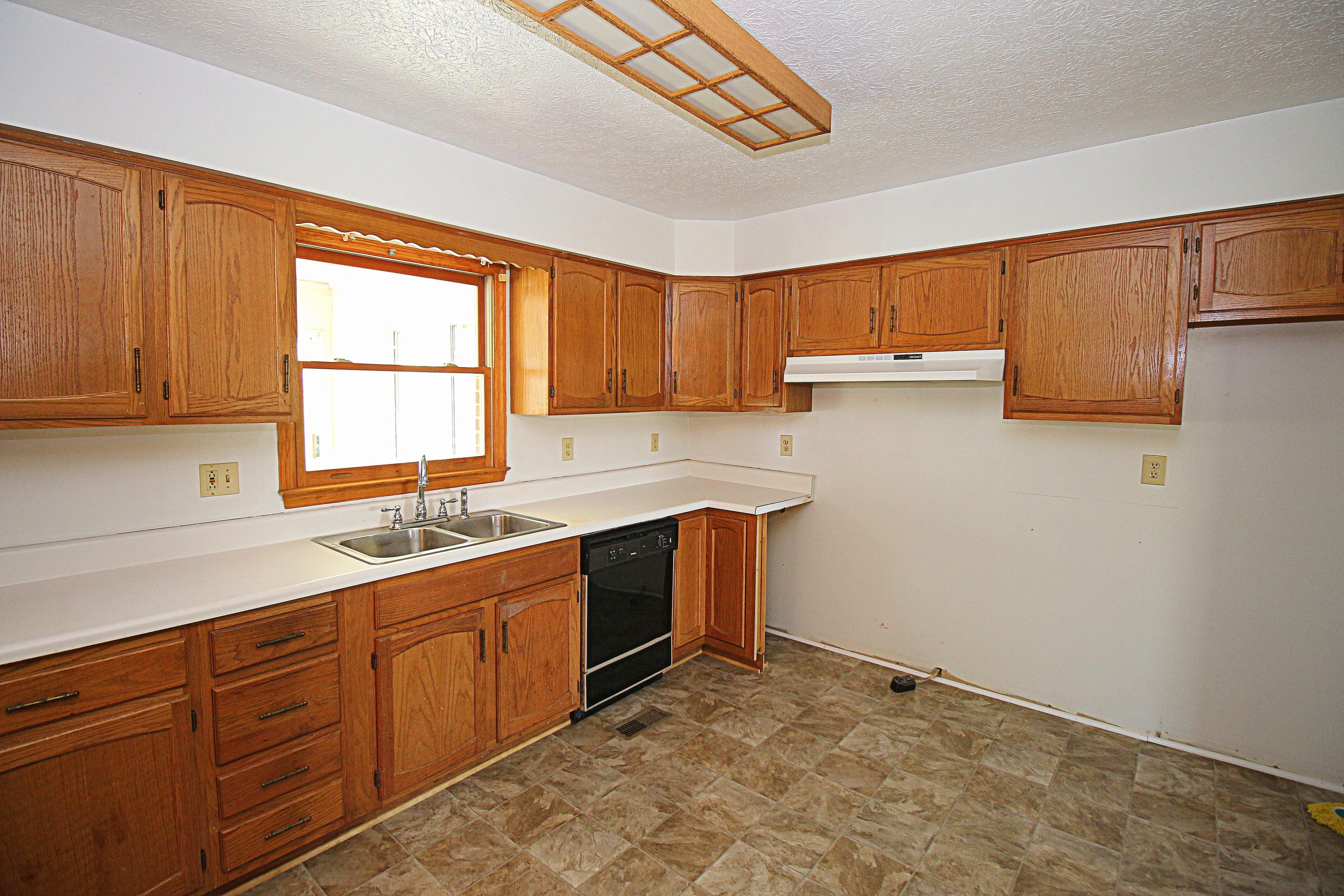 7080 Belspring Road Radford, VA 24141 - Photo 13 of 53 a kitchen with sink cabinets and window