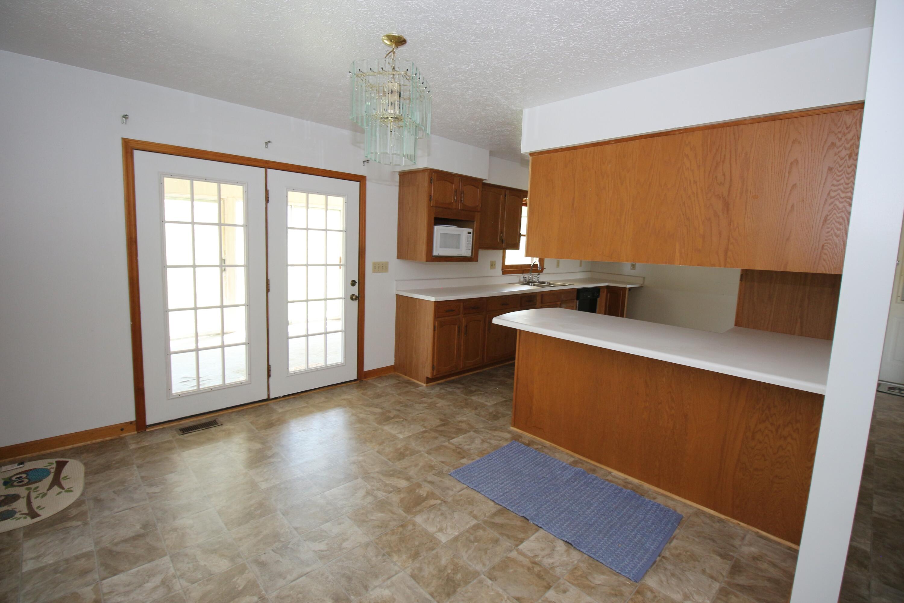 7080 Belspring Road Radford, VA 24141 - Photo 16 of 53 a kitchen with stainless steel appliances granite countertop a sink stove and refrigerator