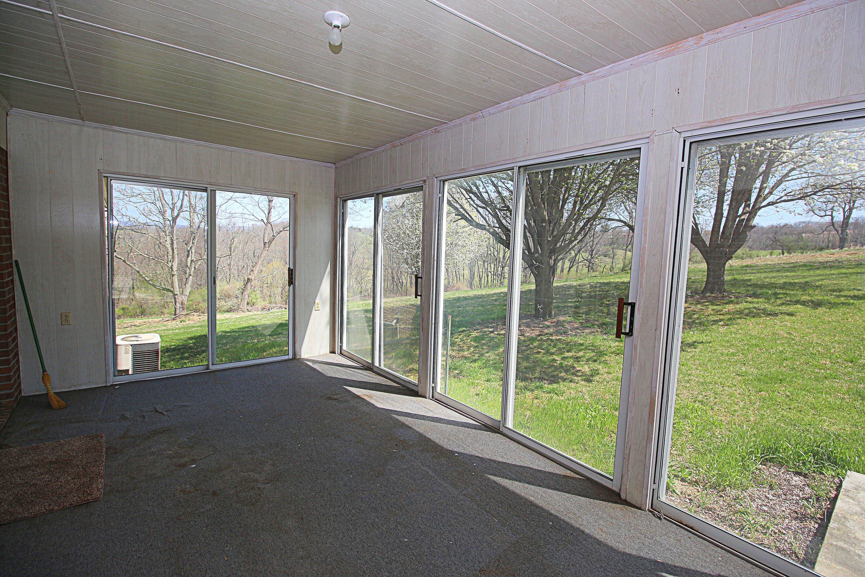 7080 Belspring Road Radford, VA 24141 - Photo 18 of 53 a view of a room with large windows and wooden fence