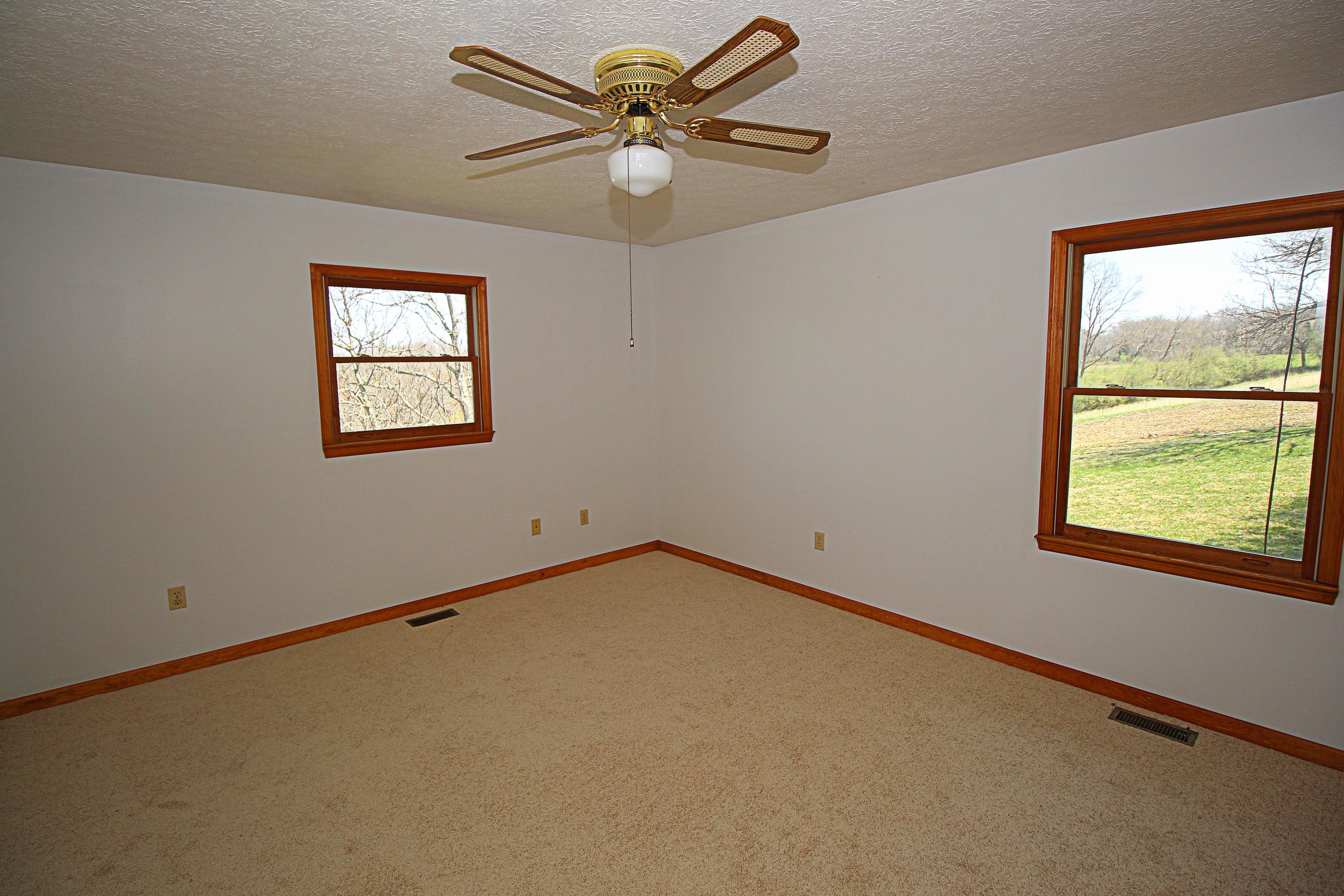 7080 Belspring Road Radford, VA 24141 - Photo 19 of 53 an empty room with windows and fan