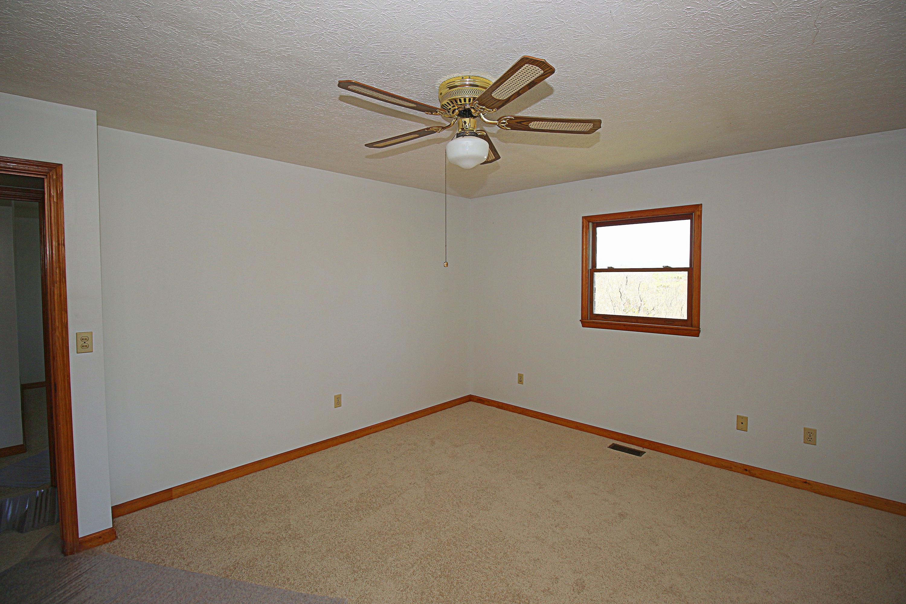 7080 Belspring Road Radford, VA 24141 - Photo 20 of 53 an empty room with windows and fan