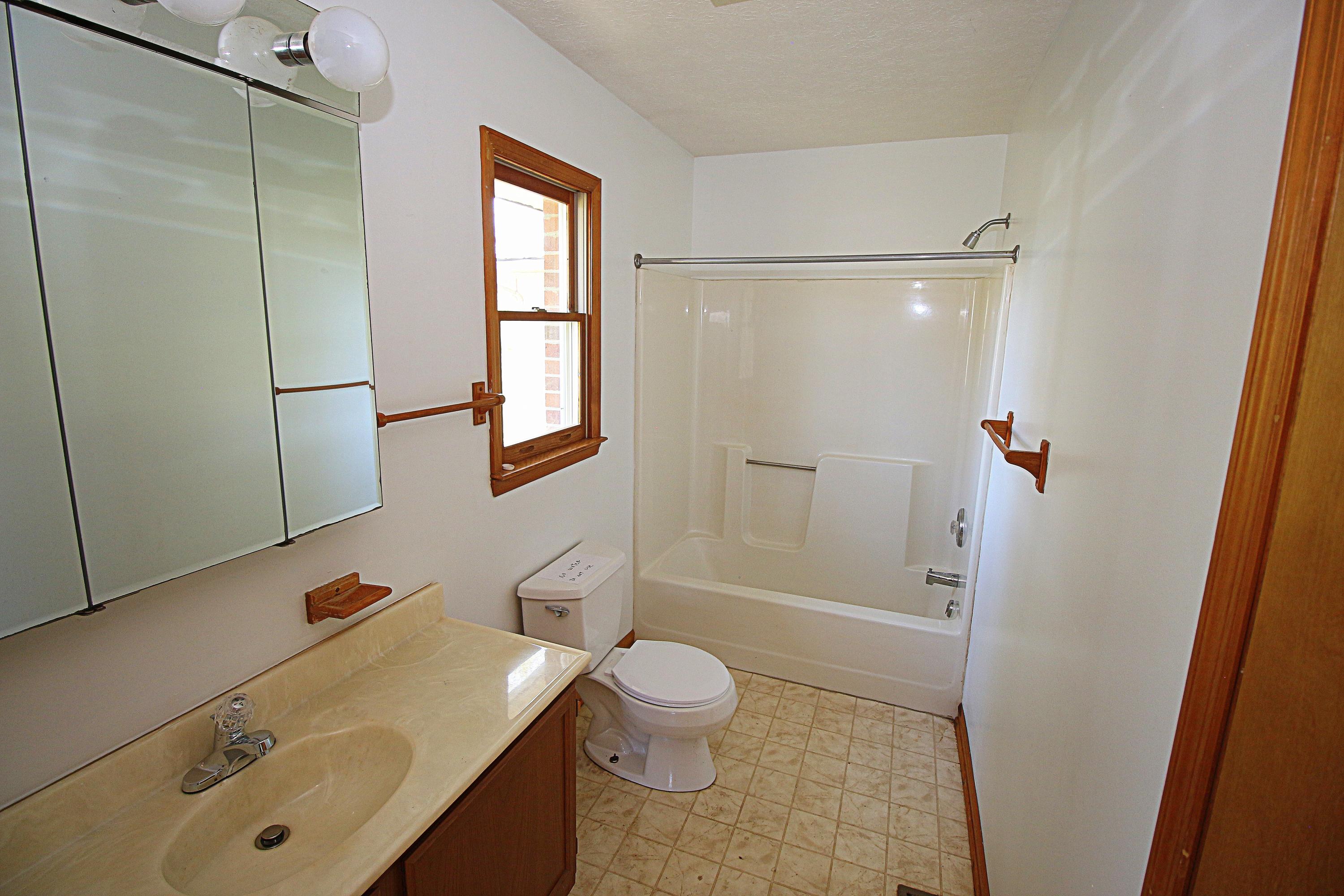 7080 Belspring Road Radford, VA 24141 - Photo 21 of 53 a bathroom with a sink a toilet and shower