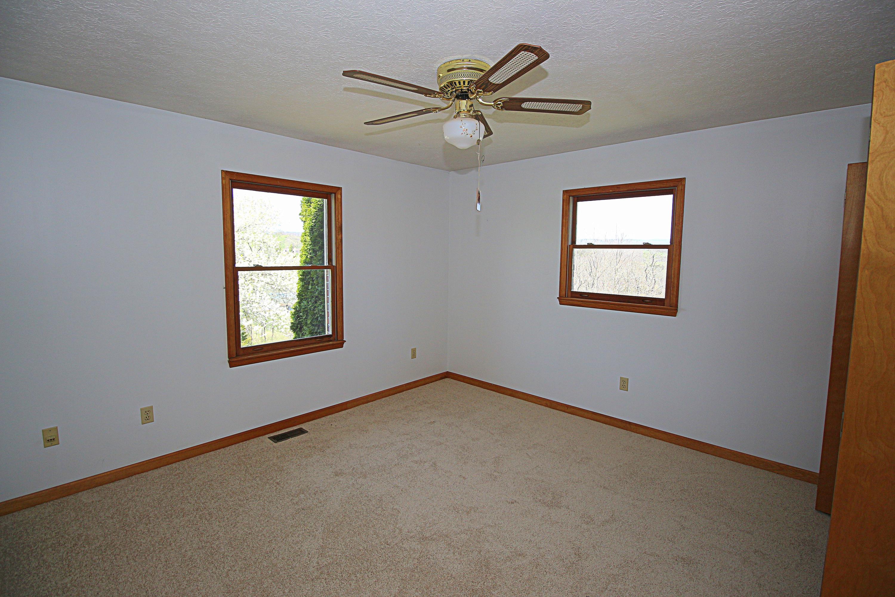 7080 Belspring Road Radford, VA 24141 - Photo 23 of 53 an empty room with a window and a fan