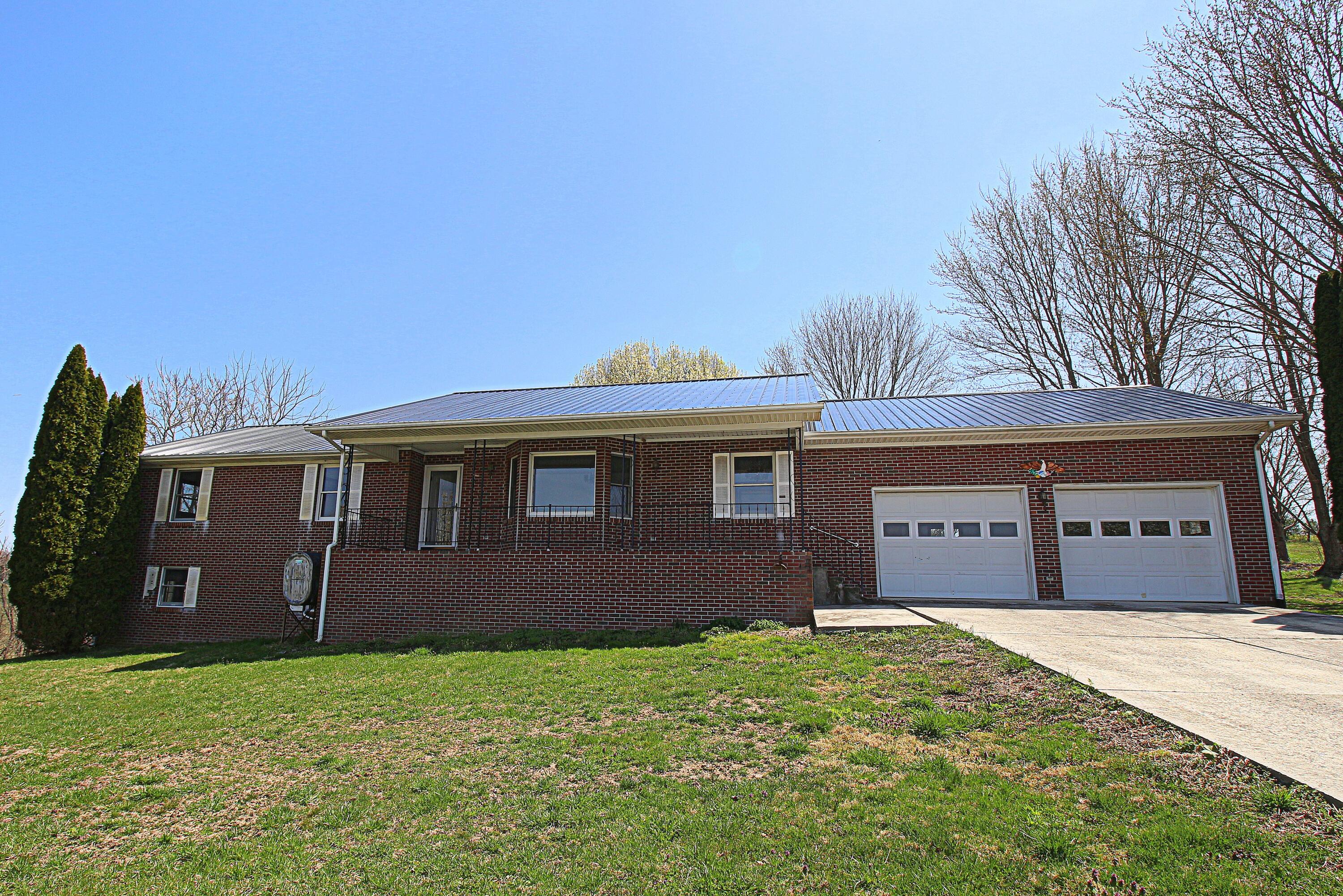 7080 Belspring Road Radford, VA 24141 - Photo 38 of 53 a front view of a house with a garden