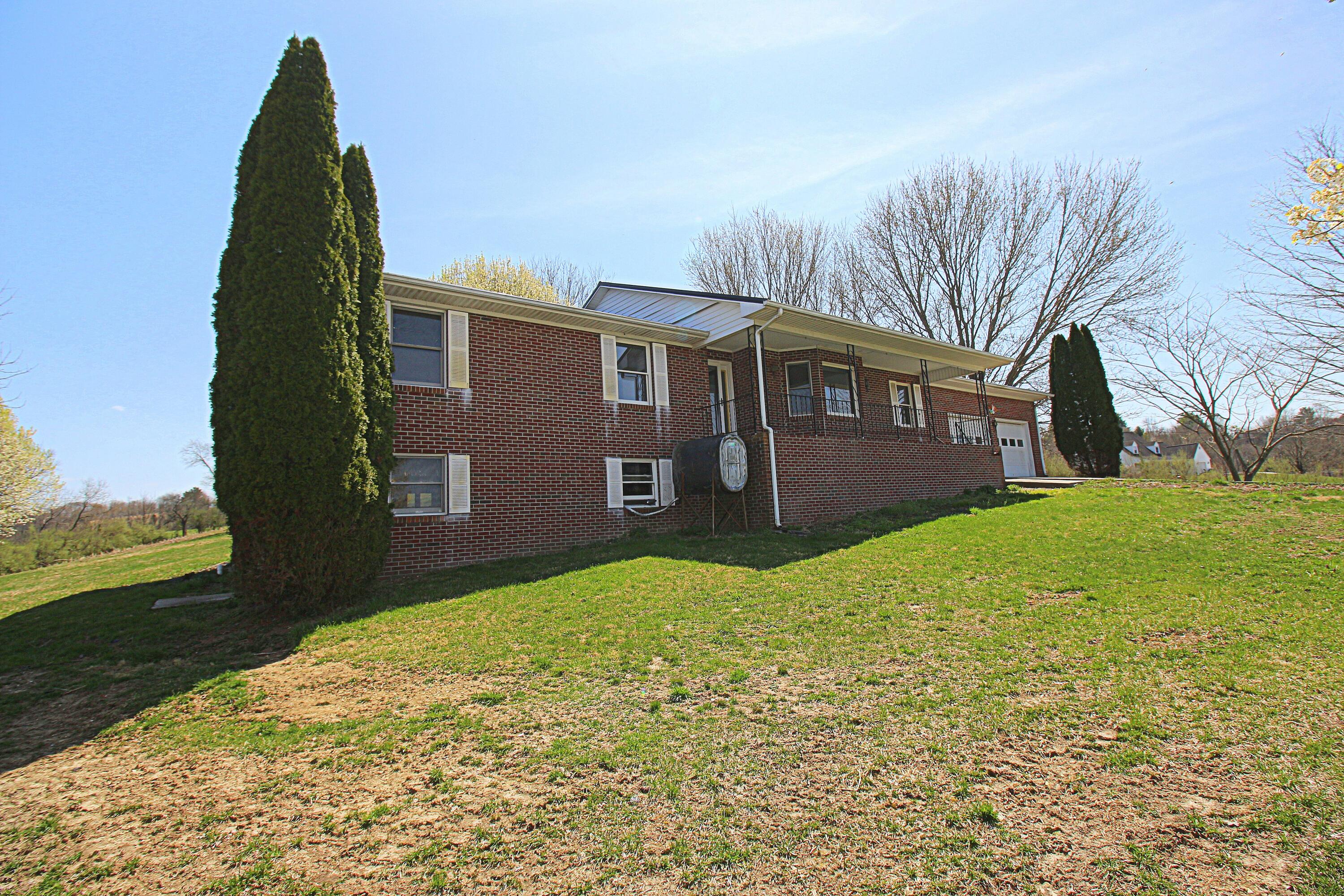 7080 Belspring Road Radford, VA 24141 - Photo 40 of 53 a backyard of a house with large trees