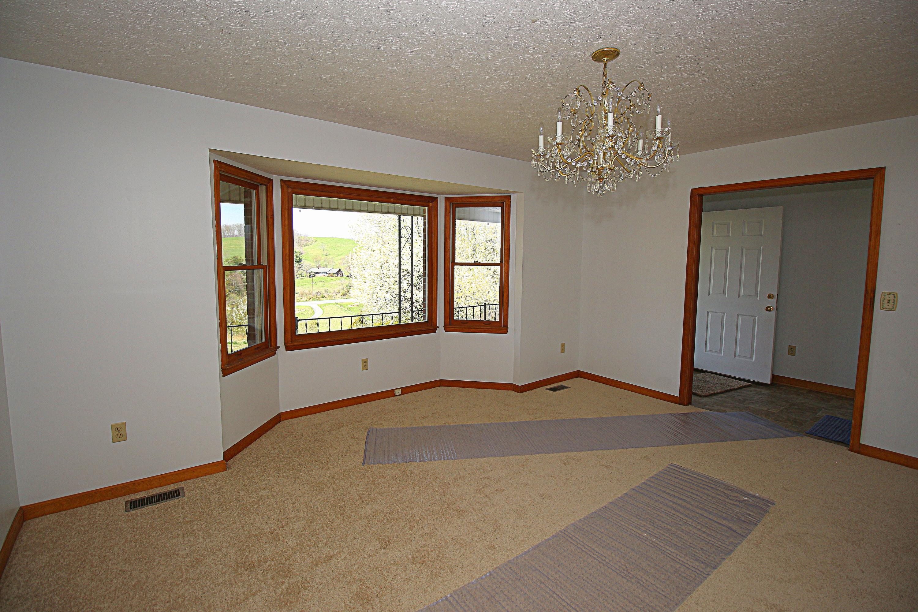 7080 Belspring Road Radford, VA 24141 - Photo 5 of 53 a view of an empty room with a window