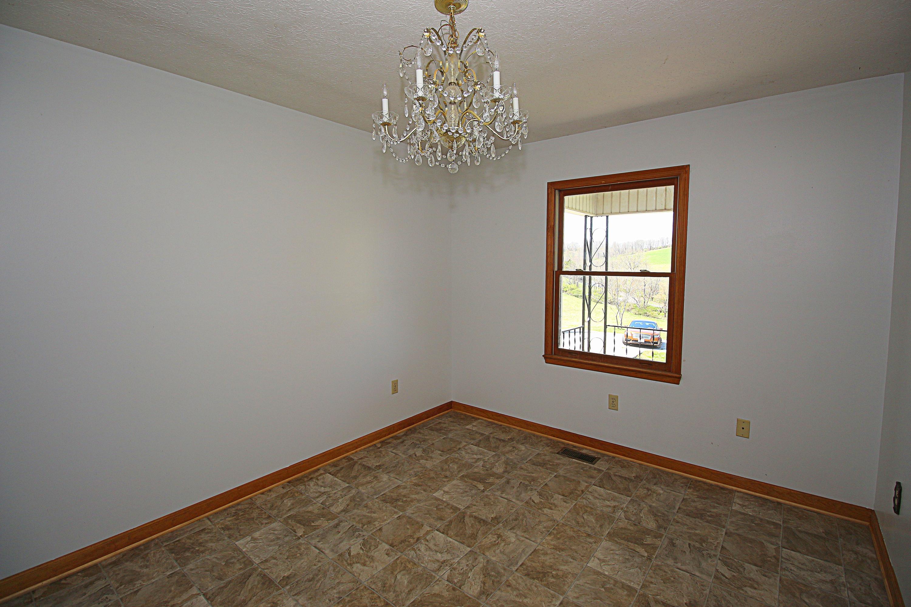 7080 Belspring Road Radford, VA 24141 - Photo 6 of 53 an empty room with windows and chandelier