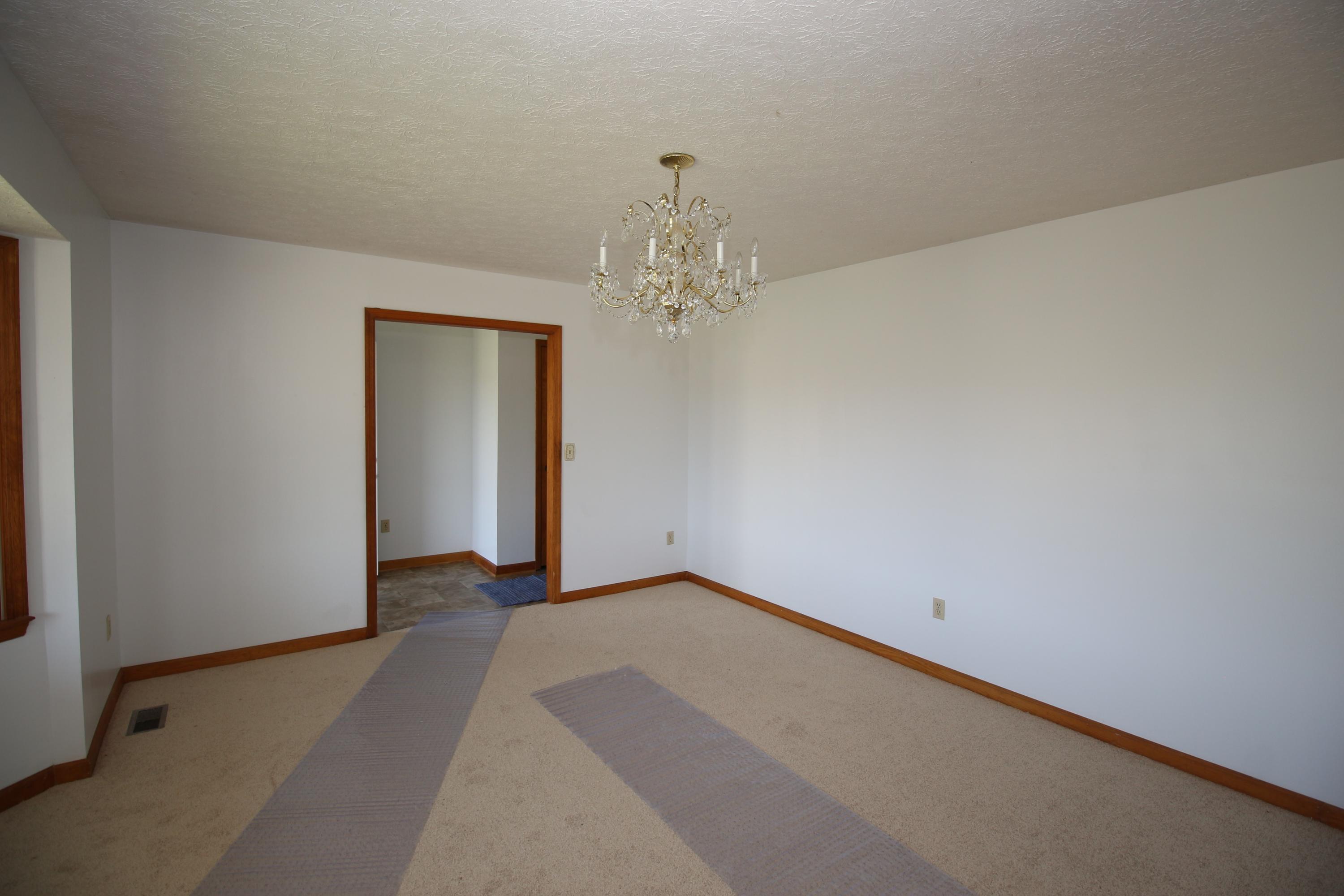 7080 Belspring Road Radford, VA 24141 - Photo 8 of 53 an empty room with a chandelier fan and closet area