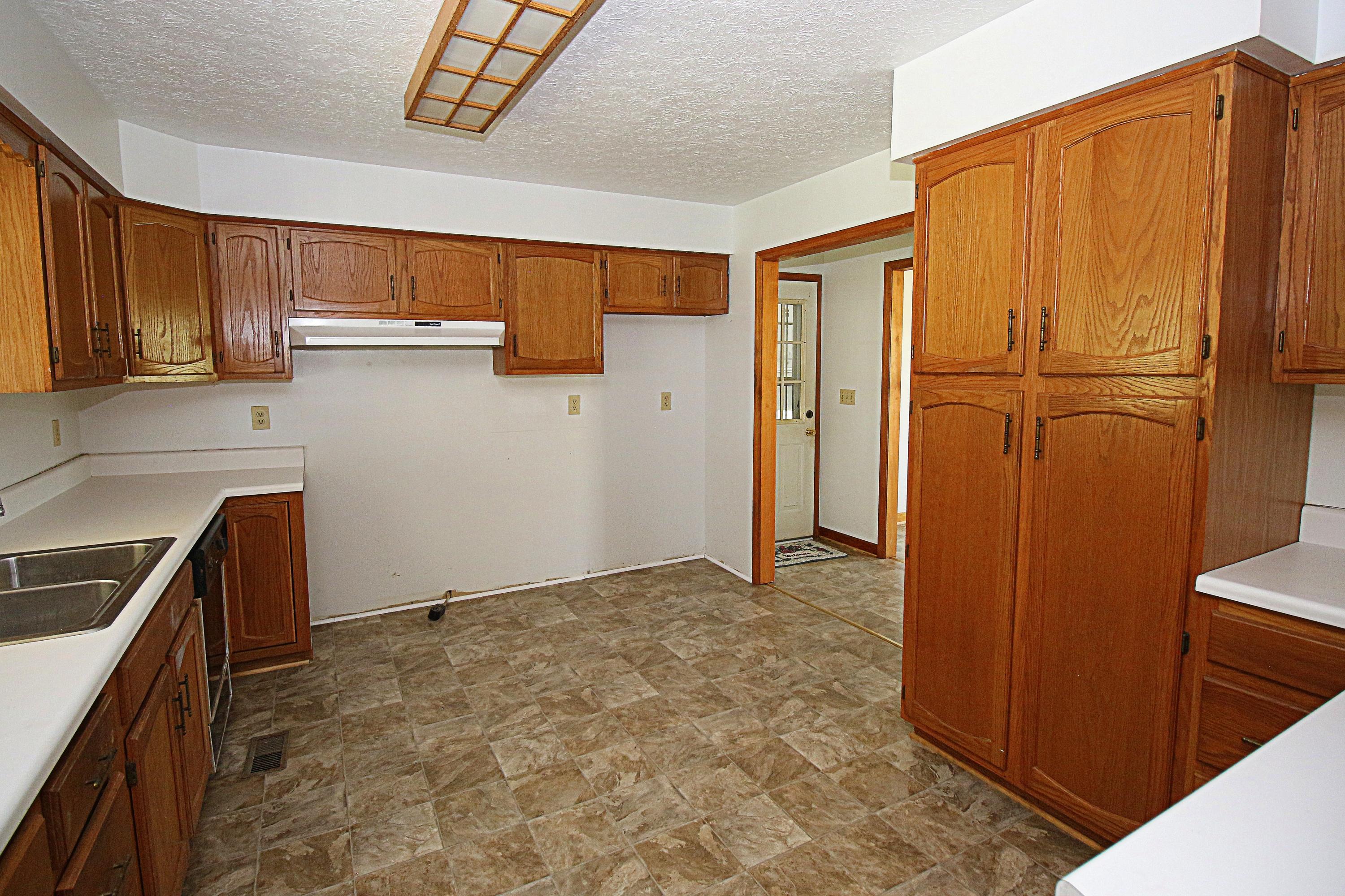 7080 Belspring Road Radford, VA 24141 - Photo 9 of 53 a view of a kitchen with wooden floor and electronic appliances