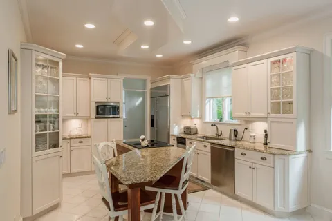 a kitchen with counter top space appliances and windows