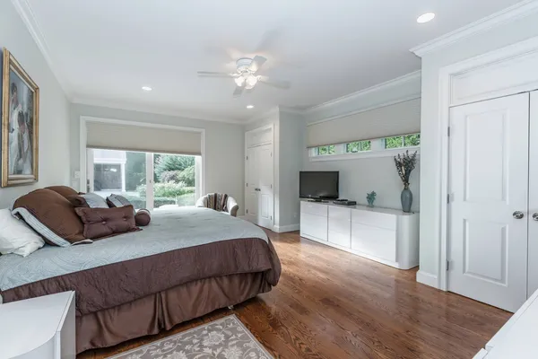 a bedroom with a large bed and a large window