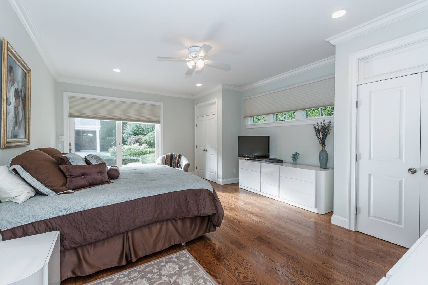 91 Beach Road Westhampton Beach, NY 11978 - Photo 14 of 23 a bedroom with a large bed and a large window