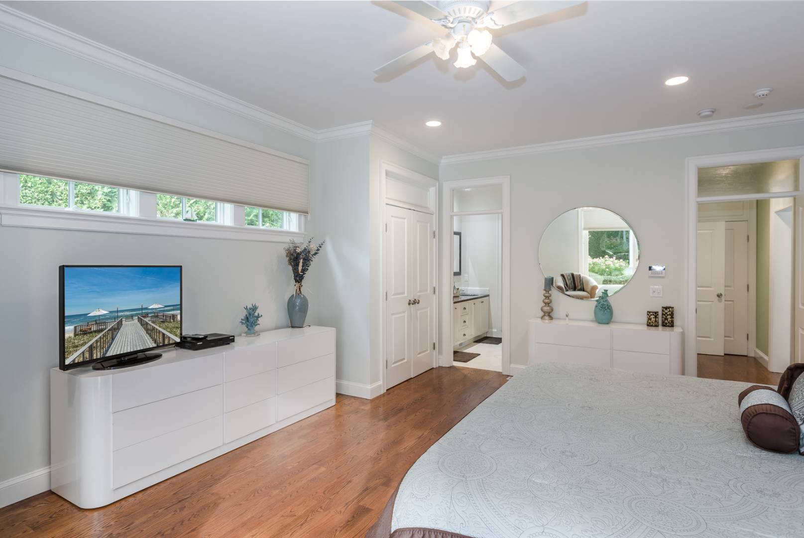 91 Beach Road Westhampton Beach, NY 11978 - Photo 15 of 23 a bedroom with a bed and a chandelier