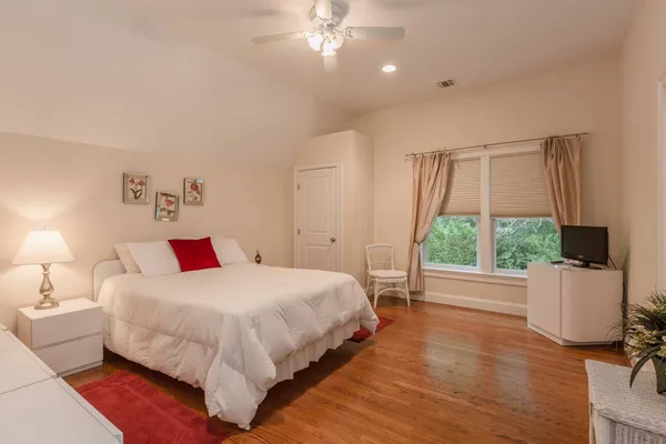 a bedroom with a bed and a large window