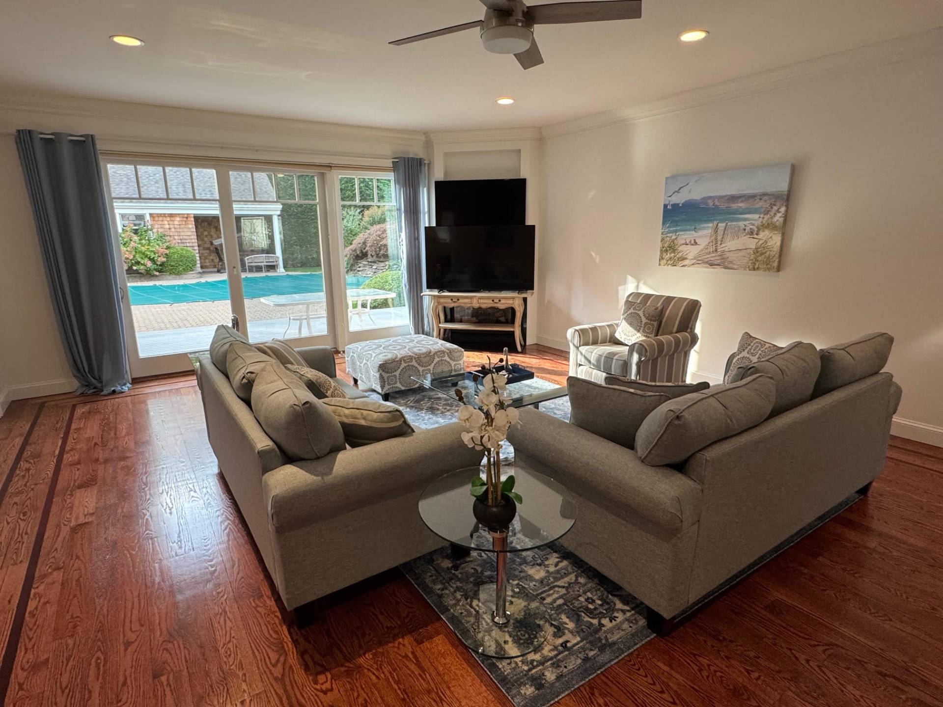 91 Beach Road Westhampton Beach, NY 11978 - Photo 4 of 23 a living room with furniture and a flat screen tv