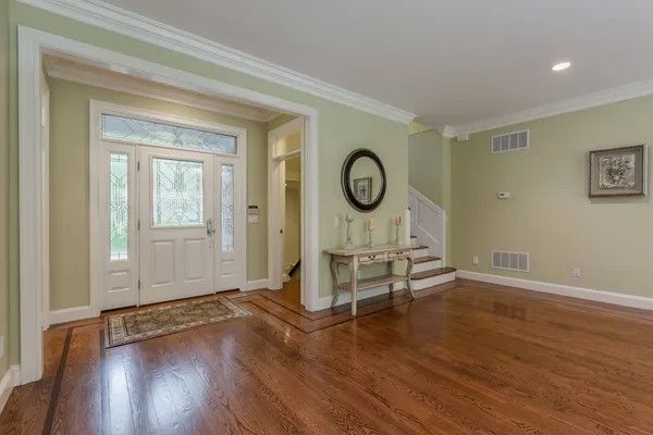 a living room with wooden floor furniture and a window