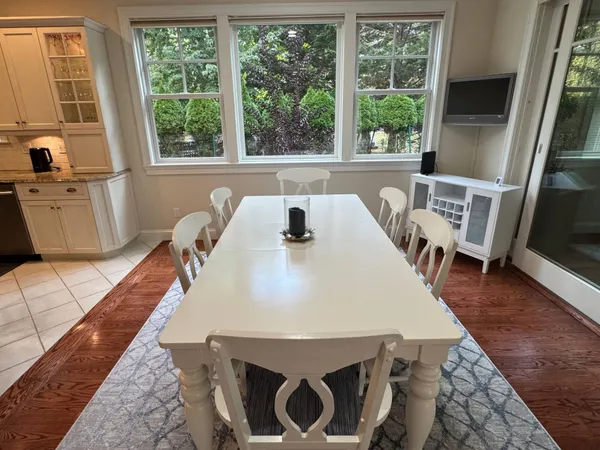 a view of a dining room with furniture window and wooden floor