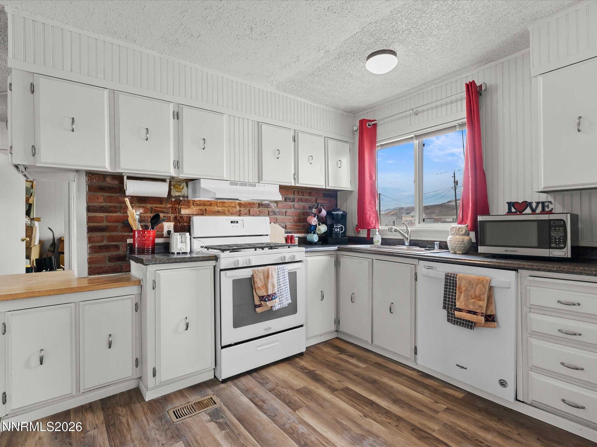 7815 Springfield Road Silver Springs, NV 89429 - Photo 14 of 46 a kitchen with stainless steel appliances granite countertop a sink stove and cabinets