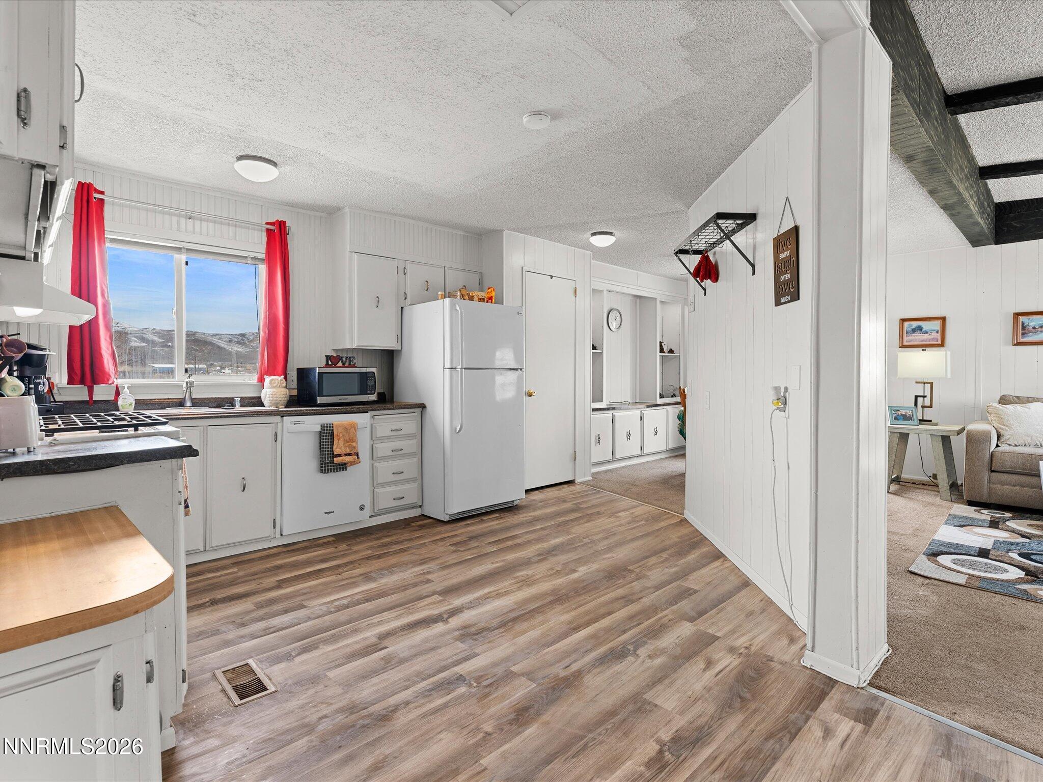 7815 Springfield Road Silver Springs, NV 89429 - Photo 15 of 46 a kitchen with cabinets and wooden floor
