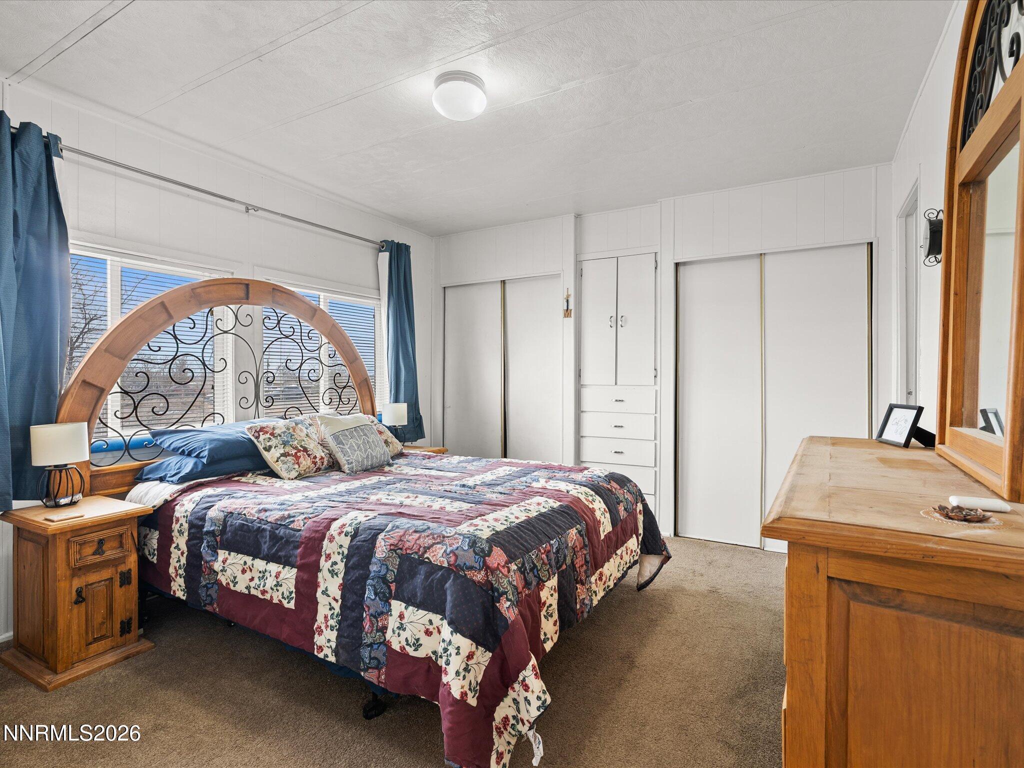 7815 Springfield Road Silver Springs, NV 89429 - Photo 18 of 46 a bedroom with a bed and a window