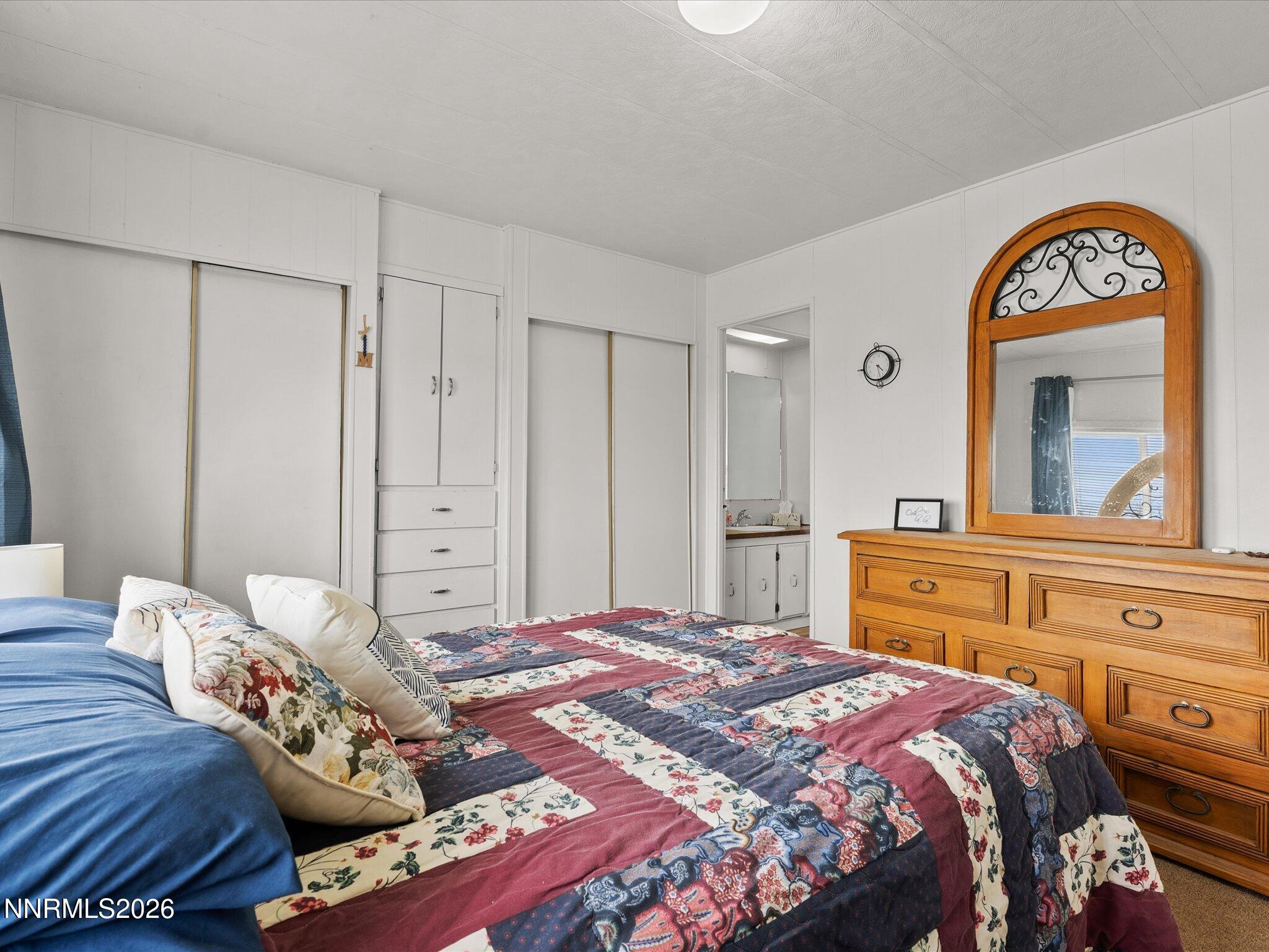 7815 Springfield Road Silver Springs, NV 89429 - Photo 19 of 46 a bedroom with a bed and a mirror