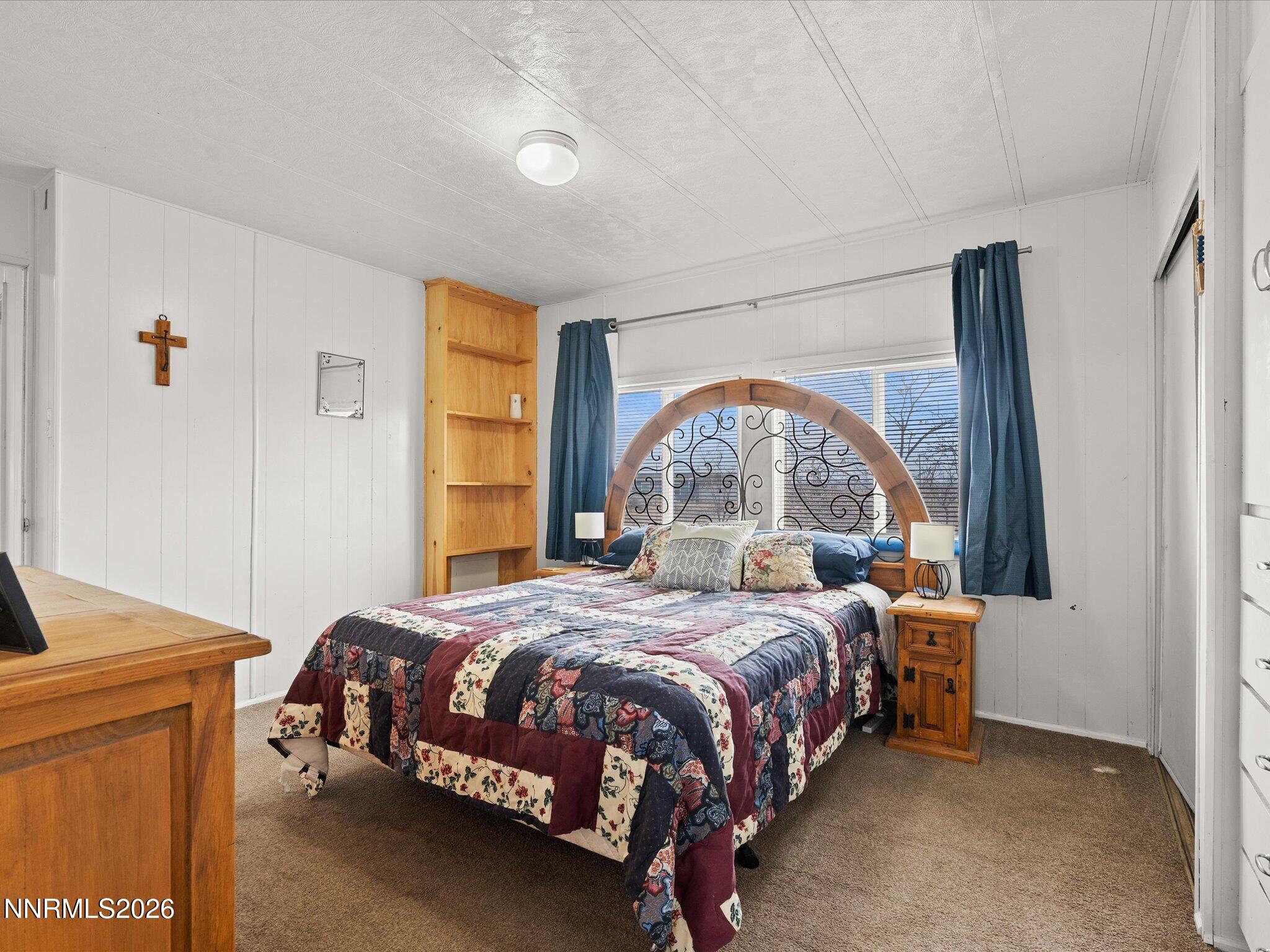 7815 Springfield Road Silver Springs, NV 89429 - Photo 20 of 46 a bedroom with a bed and a window