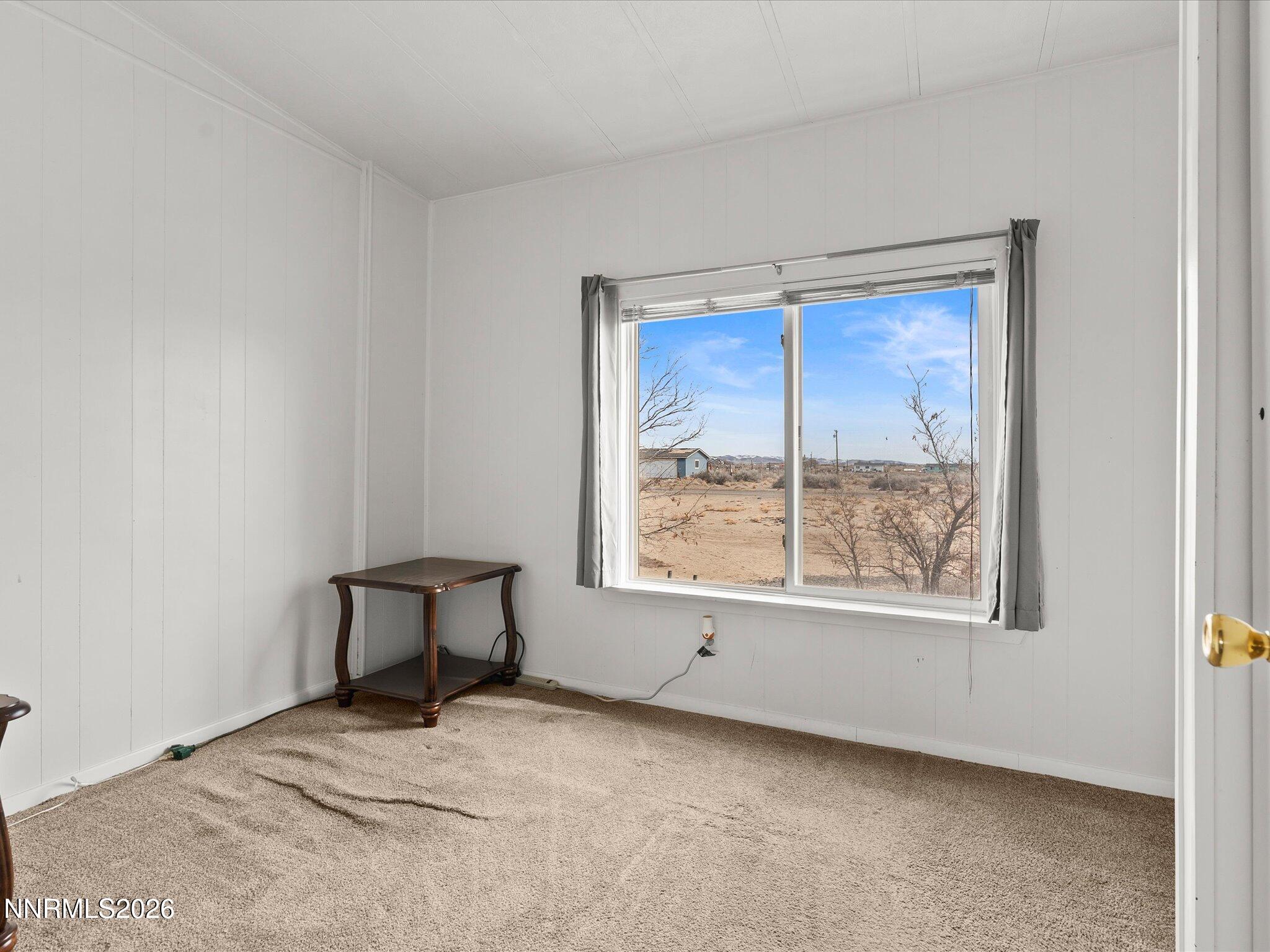 7815 Springfield Road Silver Springs, NV 89429 - Photo 22 of 46 a view of a room that has a window and a chair