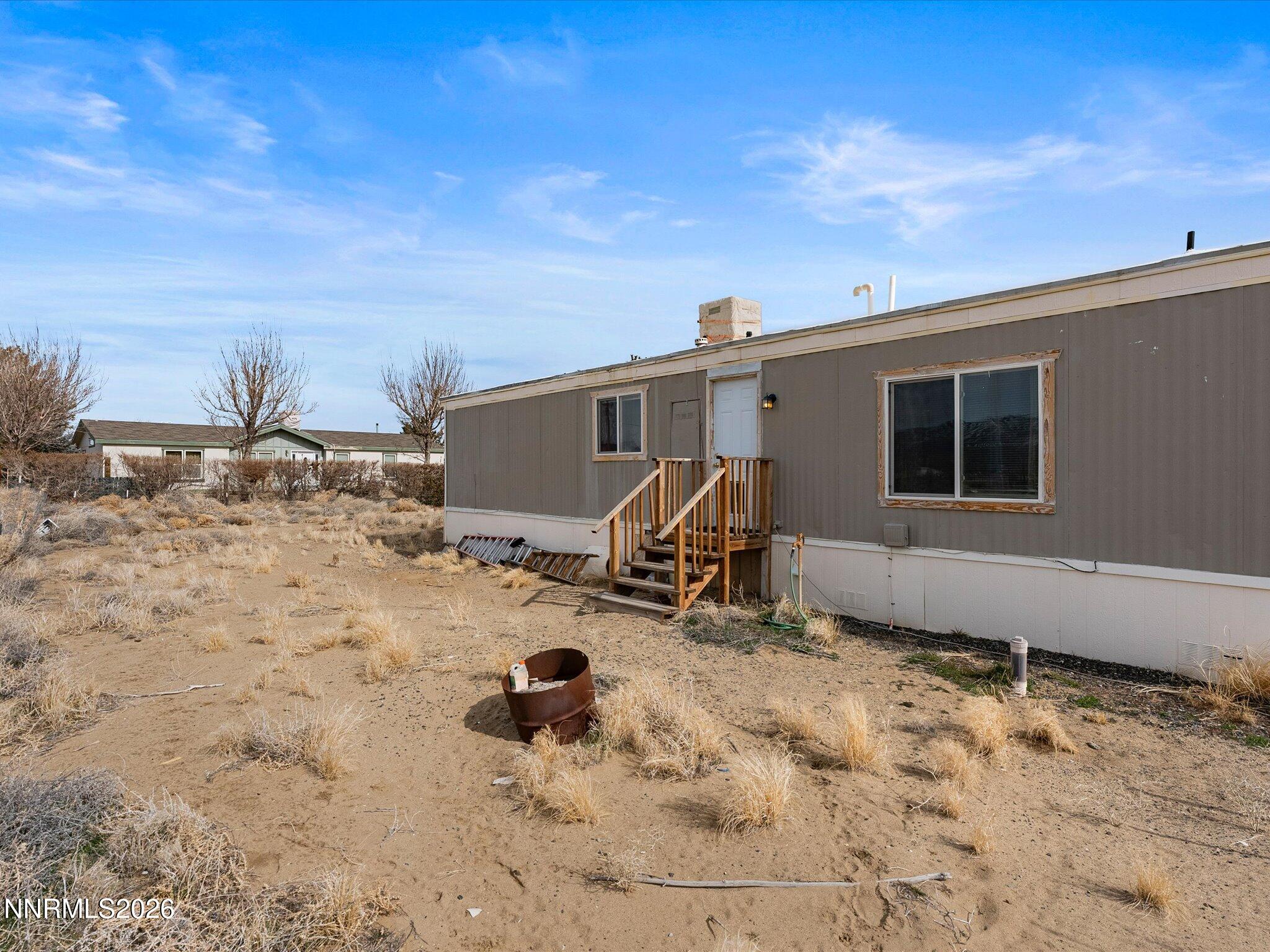 7815 Springfield Road Silver Springs, NV 89429 - Photo 25 of 46 a view of a backyard of a house with wooden fence